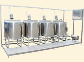 Stainless steel processing equipment with four large tanks and control panel, used in industrial manufacturing or food production.