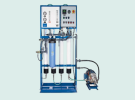 Industrial reverse osmosis water filtration system with control panel and multiple filter cartridges.